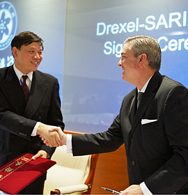 A handshake marks the partnership between Drexel and the Shanghai Advanced Research Institute.